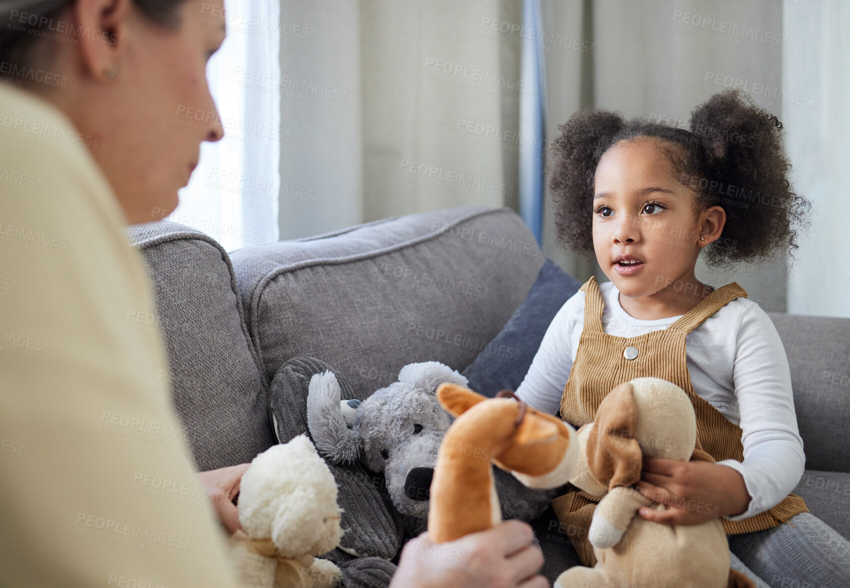 Buy stock photo Psychologist, child and teddy bear in office for therapy, ADHD assessment and notes on sofa. Mature therapist, girl and stuffed animals in practice for evaluation, sensory development and psychology