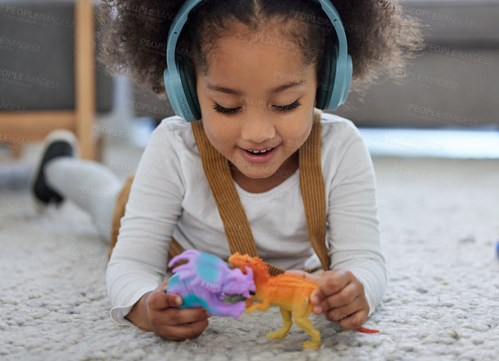 Buy stock photo Learning, playing and child with headphones or toys for development, sensory stimulation or helping. Girl kid, psychology therapy and emotion regulation with fun music in clinic for adhd diagnosis