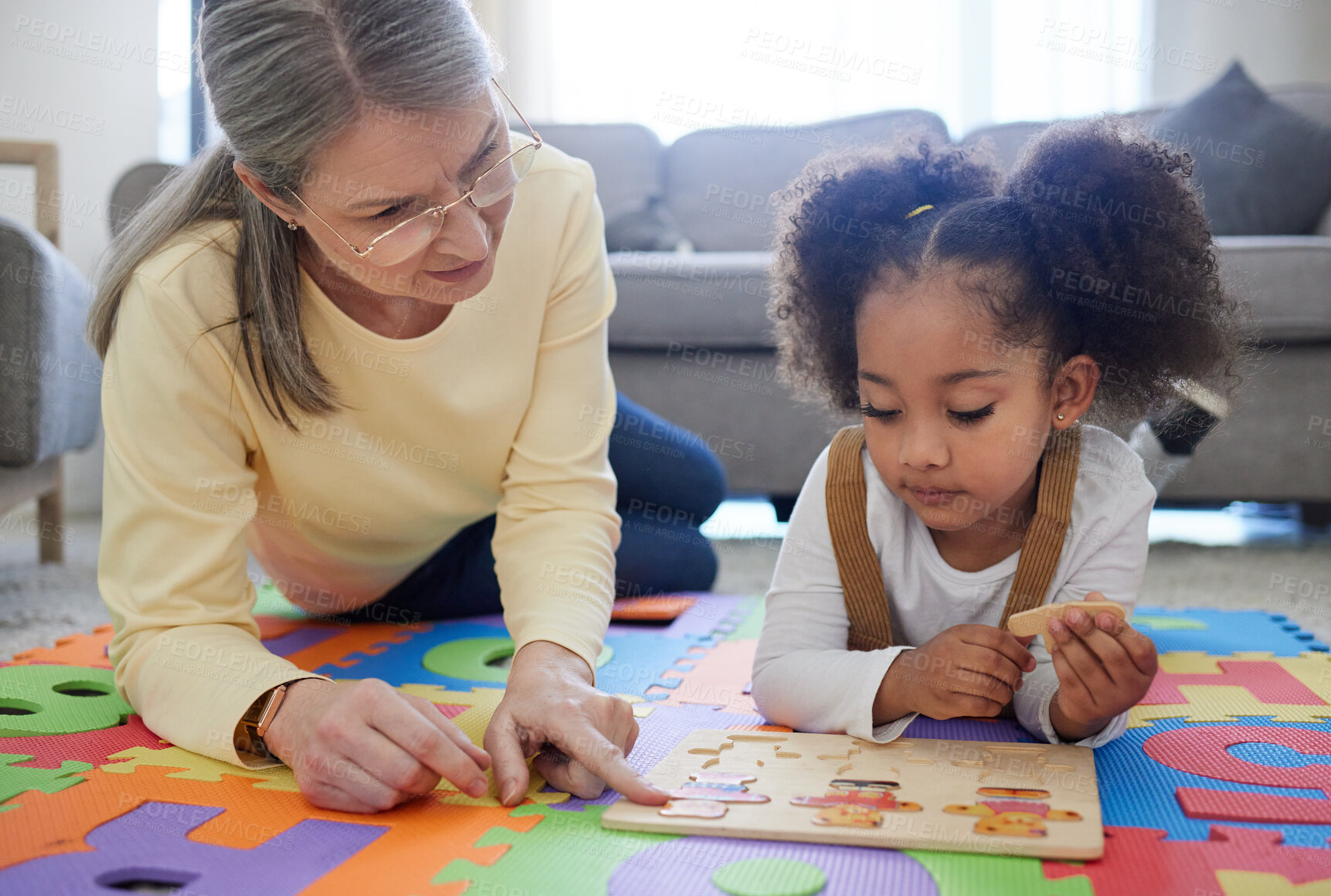 Buy stock photo Teacher, therapist and child with puzzle for education, assisted learning or early childhood development. Woman, little girl or kid with toys for matching, tutoring or occupational therapy at home