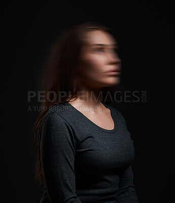 Buy stock photo Studio shot of a woman standing against a black background with a blurred face