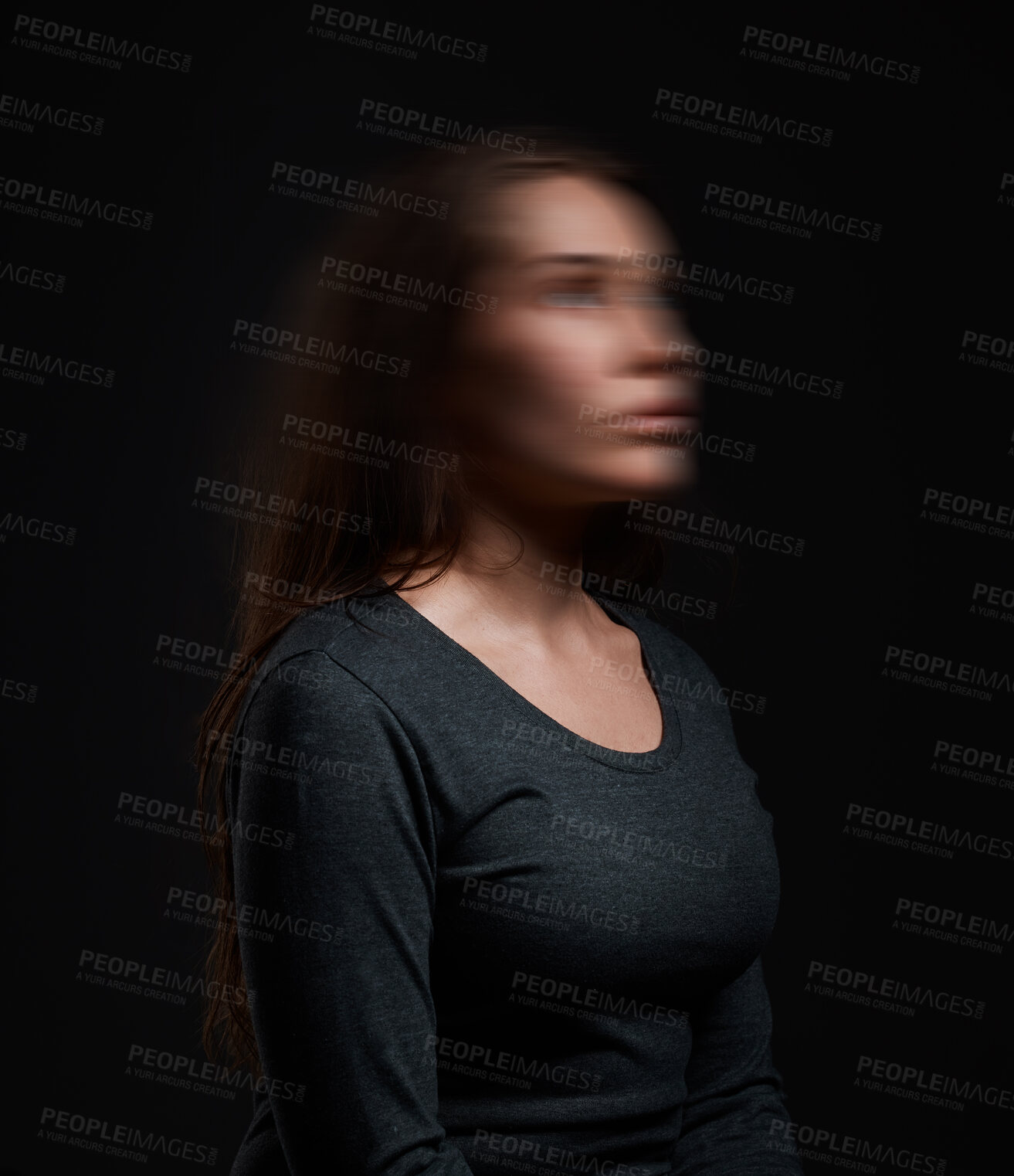 Buy stock photo Studio shot of a woman standing against a black background with a blurred face