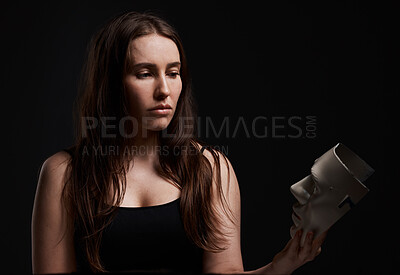 Buy stock photo Studio shot of a woman holding a mask