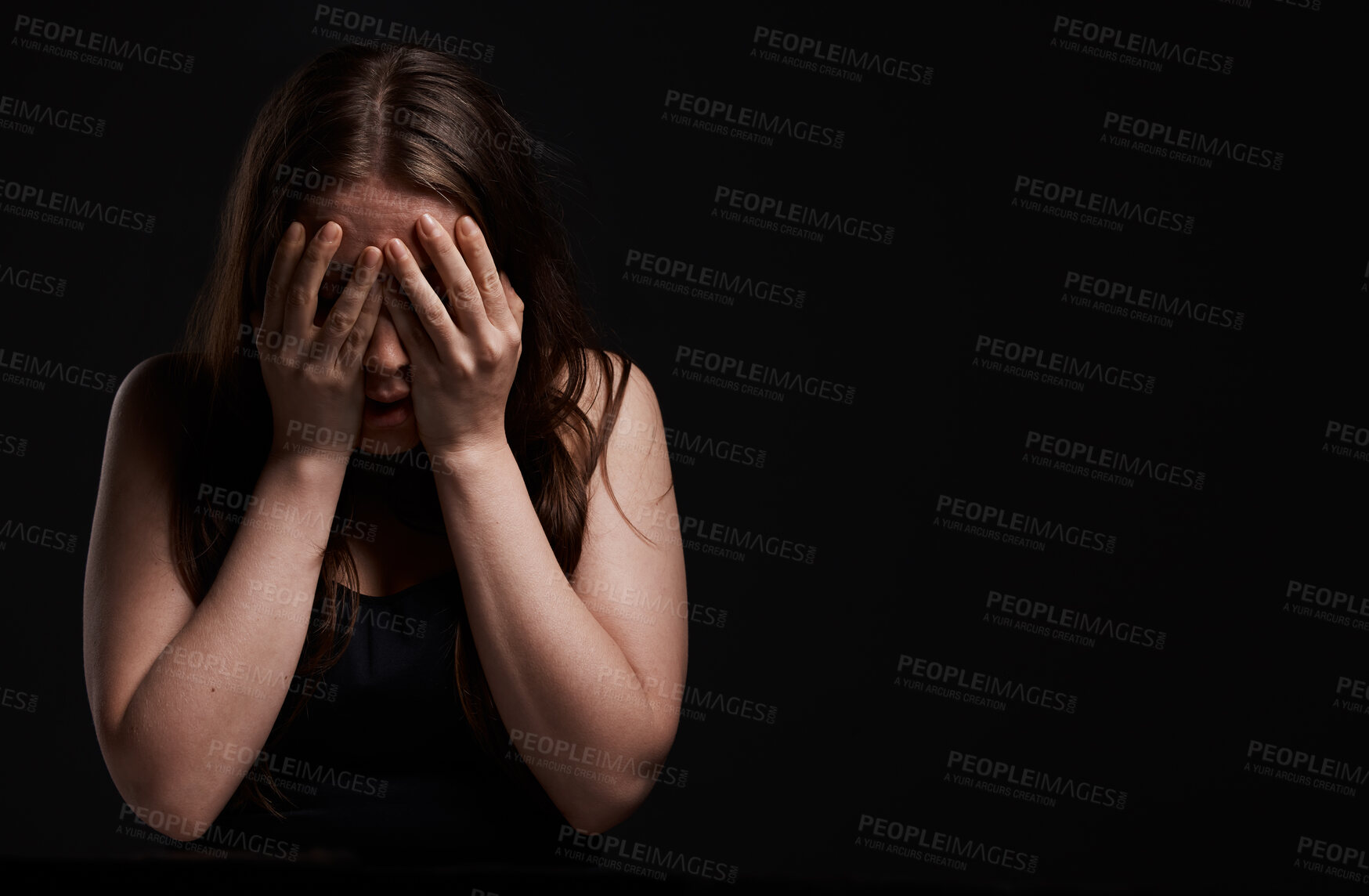 Buy stock photo Shot of a woman standing with her hands over her face