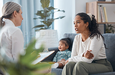 Buy stock photo Shot of an attractive young woman sitting with her daughter during a consultation with a psychologist