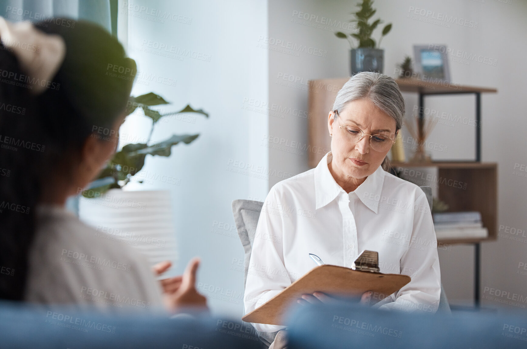 Buy stock photo Woman, therapist and writing on clipboard in consultation for mental health, psychology or healthcare. Female person or psychologist taking notes and consulting patient, anxiety or stress in therapy
