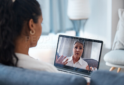 Buy stock photo Shot of an unrecognisable woman sitting and using a laptop for an online consultation with her psychologist