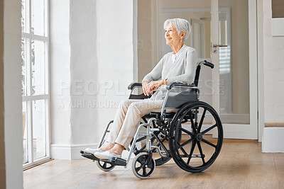 Buy stock photo Shot of a senior woman sitting in a wheelchair and looking thoughtfully out the window at home