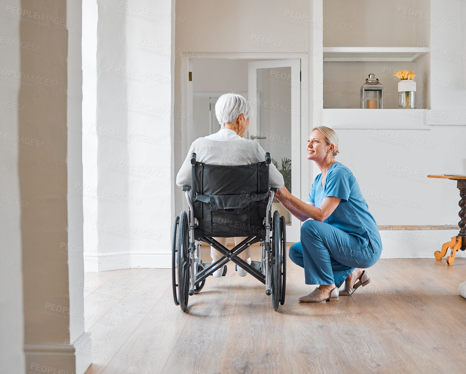 Buy stock photo Shot of a nurse caring for a senior woman in a wheelchair in a retirement home