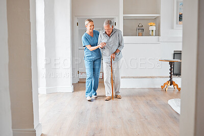 Buy stock photo Shot of a nurse assisting a senior man with a walking stick in a retirement home