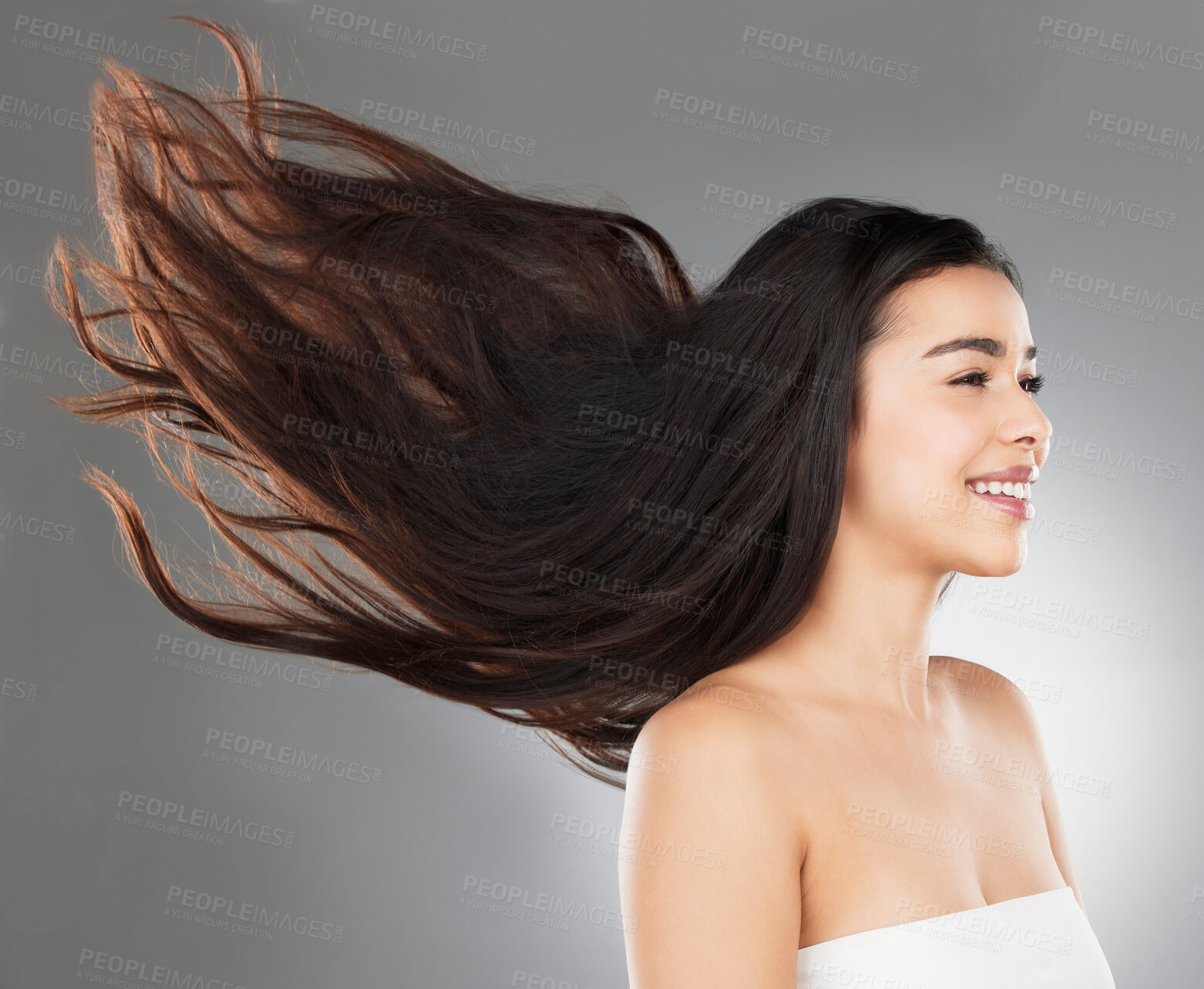 Buy stock photo Beauty, aesthetic and woman with hair movement for haircare, shampoo results and keratin treatment in studio. Smile, cosmetics and girl for satisfaction, hairstyle and salon volume on gray background