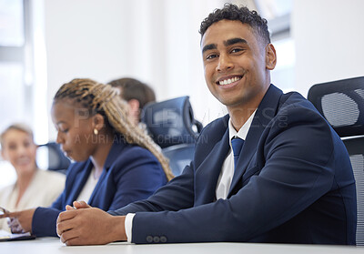 Buy stock photo Portrait of a young businessman having a meeting with his colleagues in an office