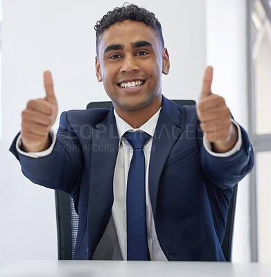 Buy stock photo Portrait of a young businessman showing thumbs up in an office