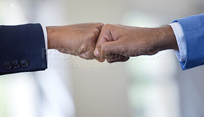 Buy stock photo Closeup shot of two unrecognisable businessmen giving each other a fist bump in an office