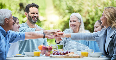 Buy stock photo Shot of a family stacking their hands in the garden outside