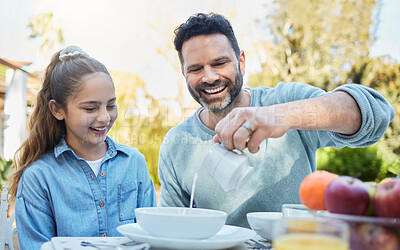 Buy stock photo Shot of a happy family having breakfast together outside in the garden