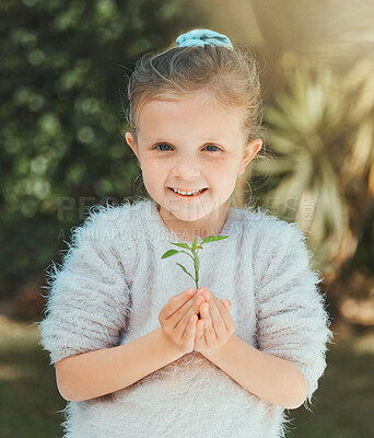 Buy stock photo Shot of a little girl holding a plant outside
