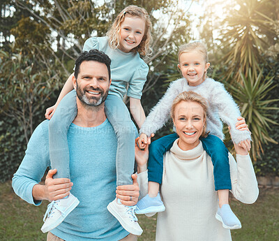 Buy stock photo Shot of a couple and their two daughters posing together in a park