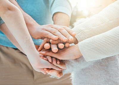 Buy stock photo Shot of a group of unrecognizable family members stacking their hands outside