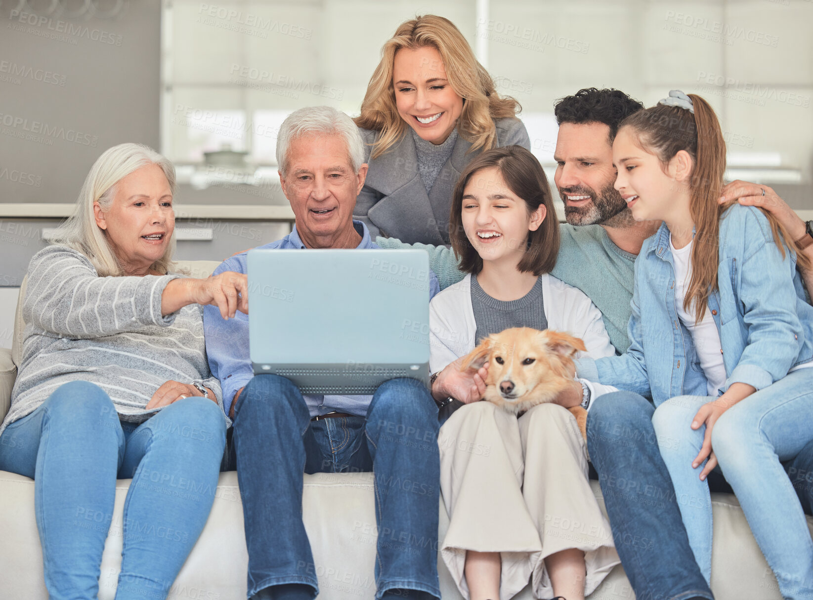 Buy stock photo Big family, smile and relax with laptop on sofa for internet, connection and watching film together. Parents, grandparents and children with dog at home for streaming, network or online movie website