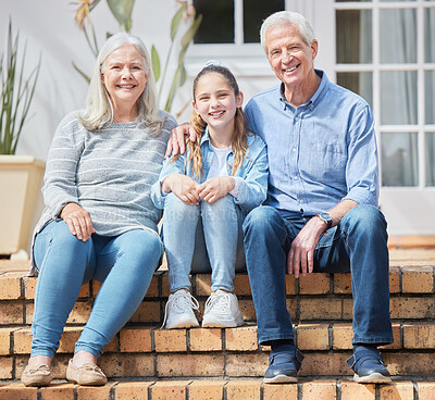 Buy stock photo Full length shot of a to grandparents sitting and bonding with their granddaughter outside