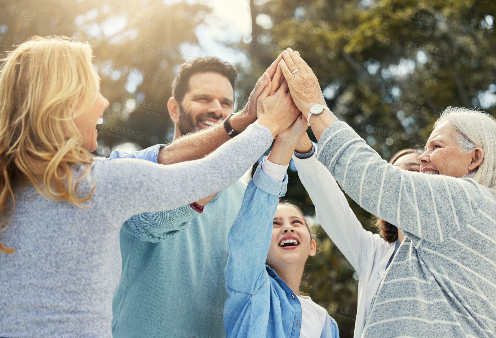 Buy stock photo High five, happy and big family in park for support, unity and connection for teamwork in nature. Hands together, success or excited people with win gesture for motivation, partnership or celebration