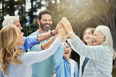 Buy stock photo Shot of a family giving each other a high five in the garden at home