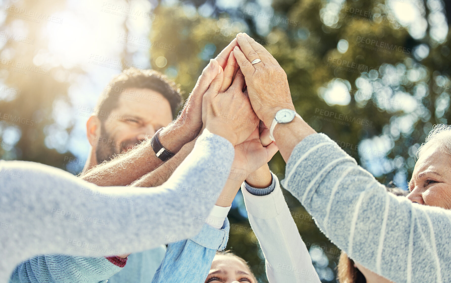 Buy stock photo High five, outdoor and hands of family in nature for support, unity and connection together in park. Happy, generations and people with win gesture for motivation, partnership or celebration in field