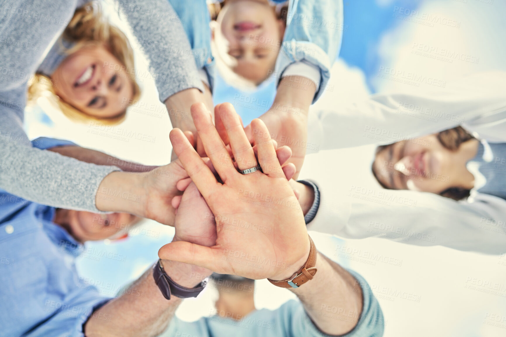 Buy stock photo Shot of a family stacking their hands in the garden outside