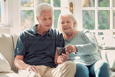 Buy stock photo App, phone and senior couple on sofa in home living room together for communication or retirement. Love, smile or social media with mature man and woman in apartment for internet browsing or search