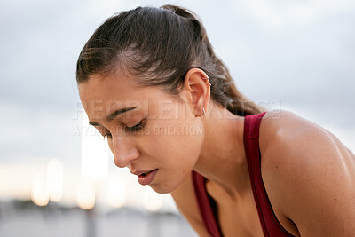 Buy stock photo Shot of a young woman taking a break while on a run outside