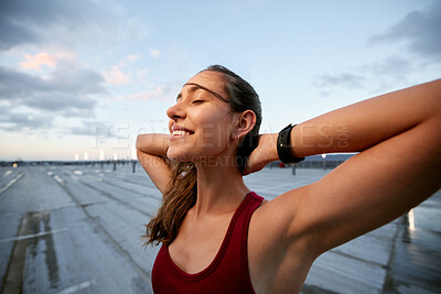 Buy stock photo Shot of a young woman taking a break while exercising outside