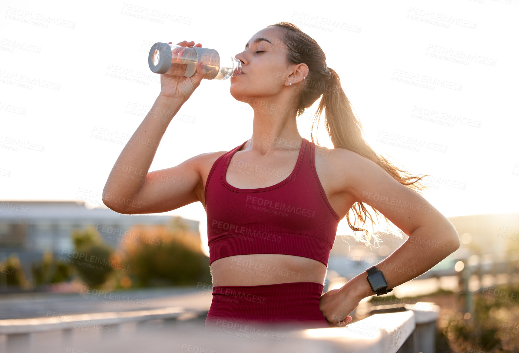 Buy stock photo Woman, drinking water and break in city for fitness, catching breath and electrolytes for wellness. Runner, bottle or fresh air in Italy for sports, thirsty or tired in town and exhausted in training