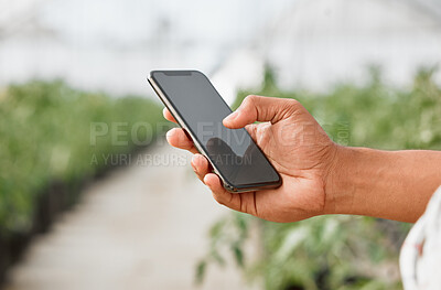 Buy stock photo Closeup shot of an unrecognisable man using a cellphone while working on a farm
