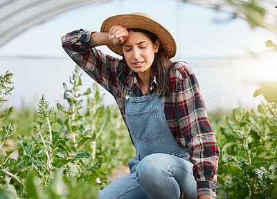 Buy stock photo Shot of a young woman looking exhausted while working on a farm