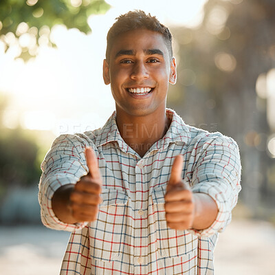 Buy stock photo Shot of a young man giving a thumbs up on a farm