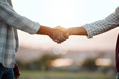 Buy stock photo Closeup shot of two unrecognisable men shaking hands on a farm