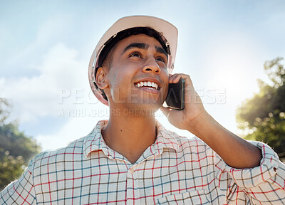 Buy stock photo Shot of a young man talking on a cellphone while working on a farm