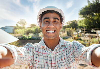 Buy stock photo Shot of a young farmer talking a selfie on a farm