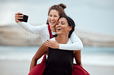 Buy stock photo Shot of two friends taking a selfie at the beach