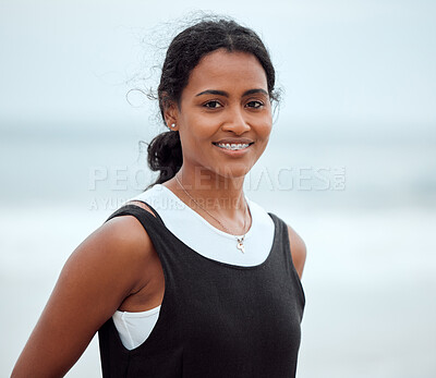 Buy stock photo Shot of a young woman standing on the beach