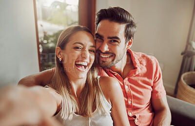 Buy stock photo Shot of a young couple taking a selfie together at home