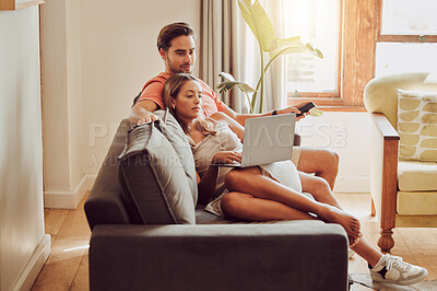 Buy stock photo Shot of a young couple using a laptop together at home