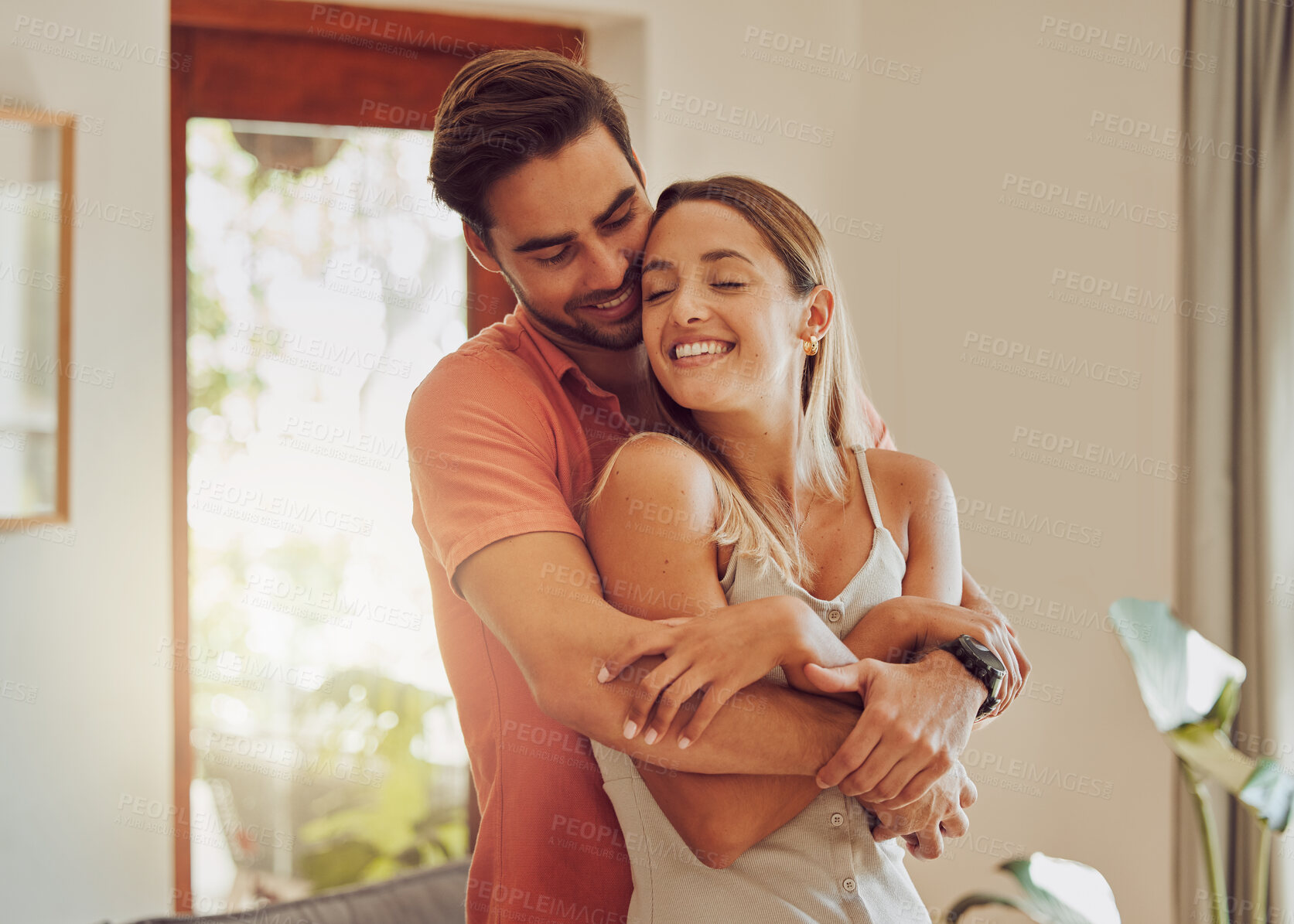 Buy stock photo Romance, hug and happy couple in living room for morning bonding, care and relationship commitment in home. Love, man and woman in lounge with fun embrace, support and smile together in apartment.