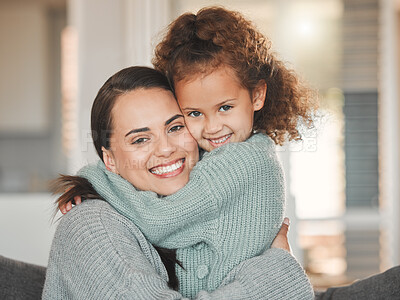 Buy stock photo Shot of a mother and daughter sitting on the sofa at home