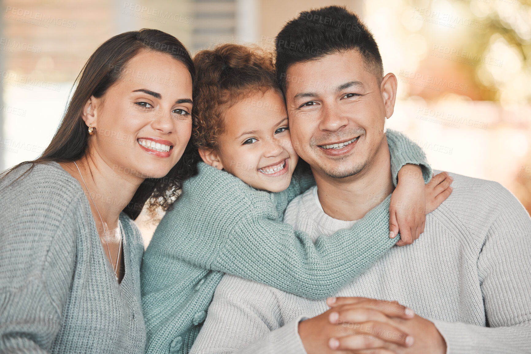 Buy stock photo Hugging, portrait and child with parents on sofa in home for bonding, security and family time. Happy, relax and girl kid embracing mom and dad in living room for care, love or connection at house.