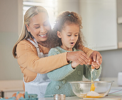 Buy stock photo Baking, kitchen and grandmother with child in home for learning, development or growth. Ingredients, eggs and senior woman teaching girl kid to prepare cookies, dessert or cake for bonding in house.