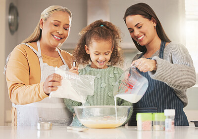 Buy stock photo Shot of a little girl baking with her mother and grandmother at home