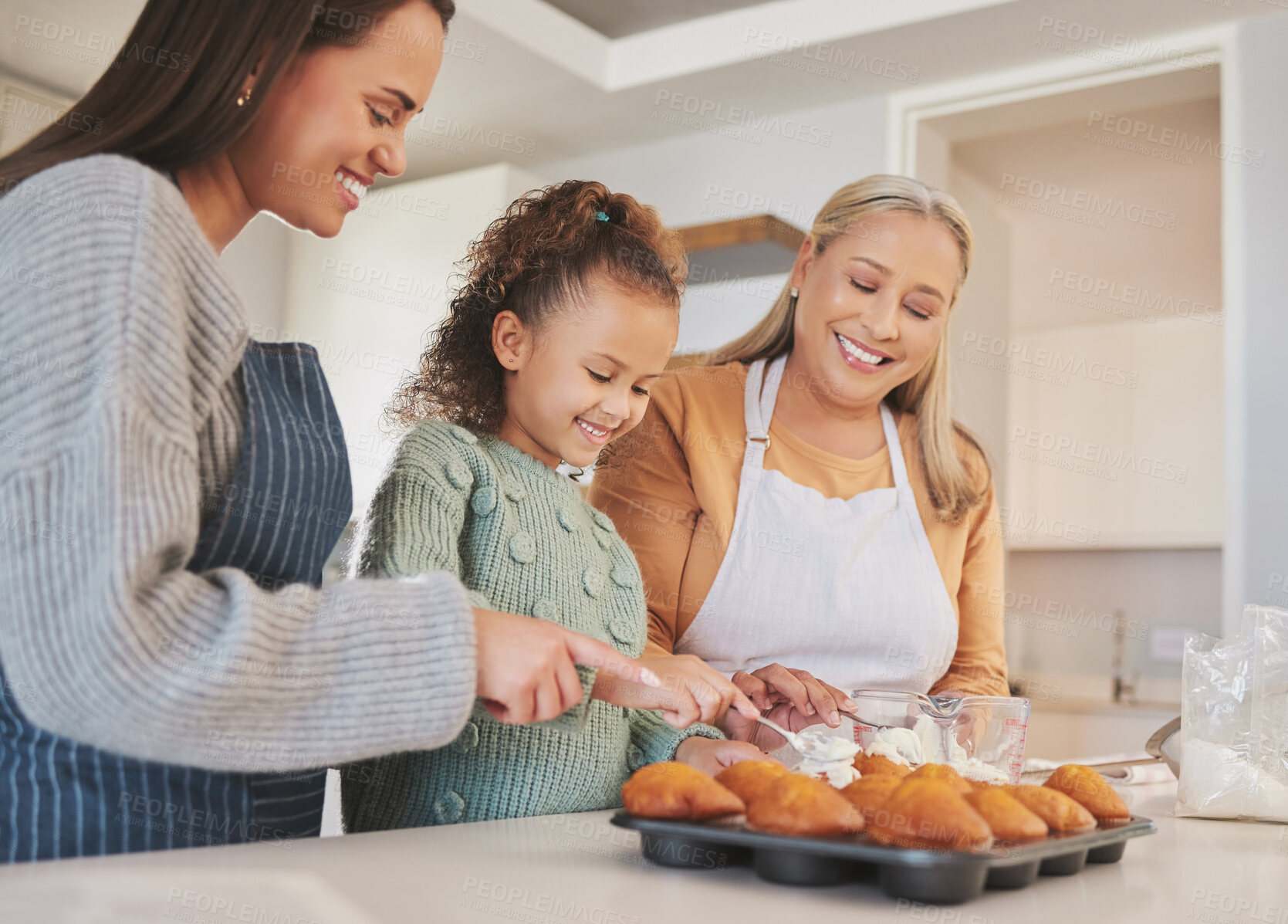 Buy stock photo Shot of a little girl baking with her mother and grandmother at home