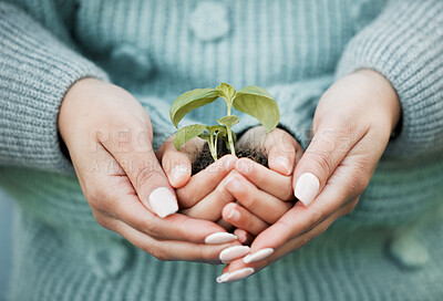 Buy stock photo Shot of a unrecognizable woman and a little girl holding a plant outside