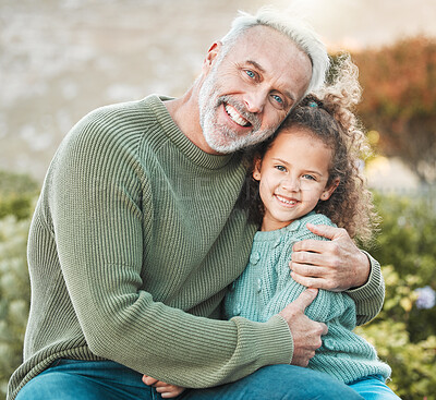 Buy stock photo Shot of a grandfather and granddaughter spending time together outside